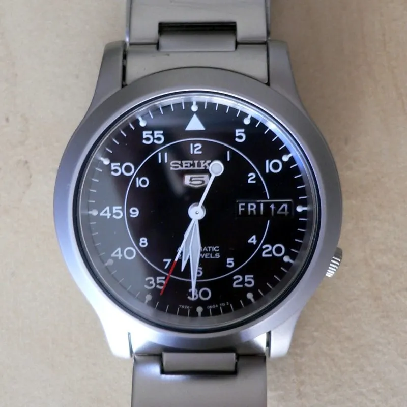 Seiko SNK809k1 med svart urtavla och monterad metallänk.