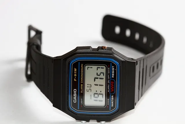 Svart Casio F-91W med blå ram runt displayen och öppet band.