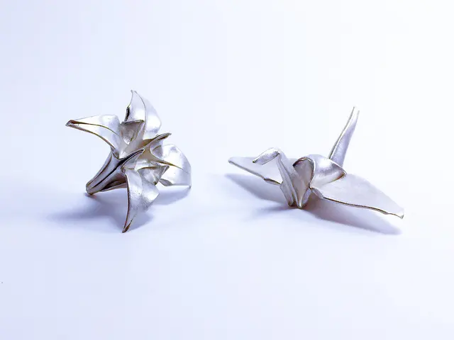 Gefaltete Kraniche aus Metallton als Beispiel für ein handwerkliches Hobby mit japanischem Motiv. Die Aufnahme zeigt fertige Arbeiten; Werkzeug und Material sind gesondert zu wählen.