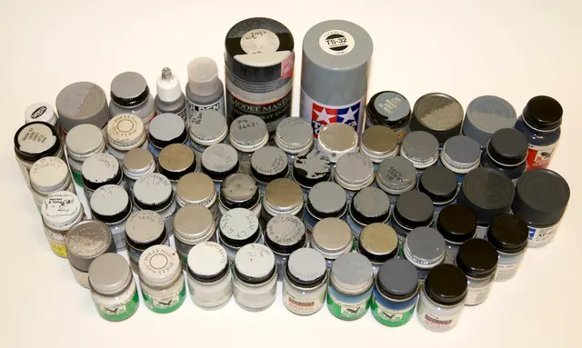 Eine Sammlung grauer Modellbaufarben verschiedener Hersteller. Kontextfoto zum vorhandenen Verbrauchsmaterial, das bei der Planung eines Projektbudgets mitgezählt wird.