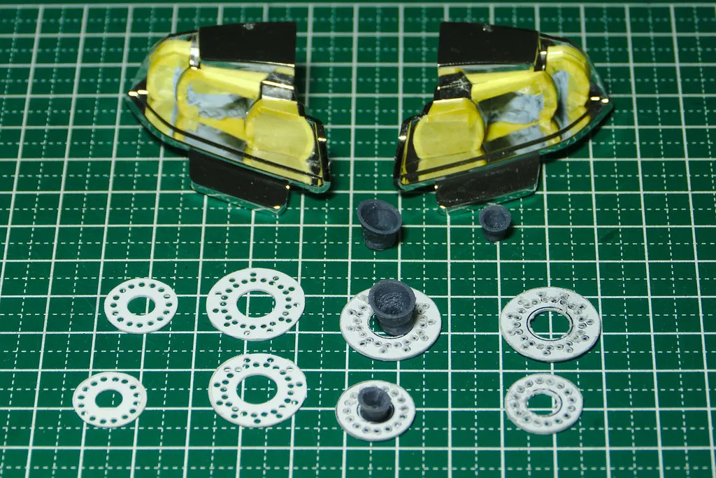 Abgeklebte Scheinwerfergehäuse und selbst gefertigte Rücklicht-Einsätze eines RC-Automodells auf einer Schneidmatte. Kontextfoto zur separaten Planung kleiner transparenter und lackierter Bereiche.